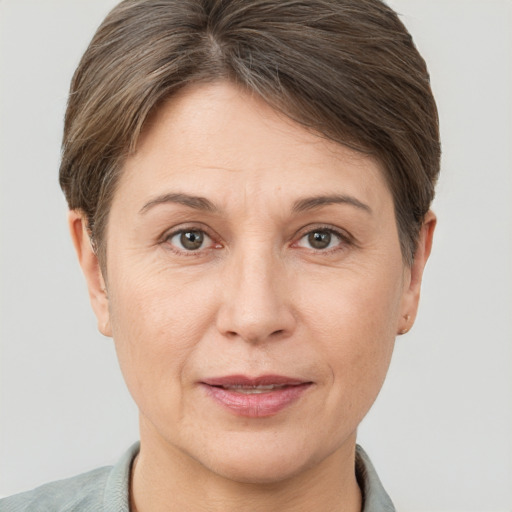 Joyful white adult female with short  brown hair and brown eyes