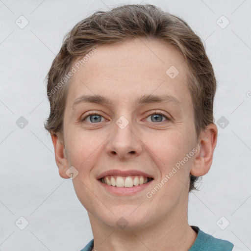 Joyful white young-adult female with short  brown hair and grey eyes