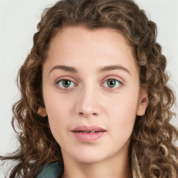 Joyful white young-adult female with long  brown hair and green eyes