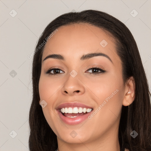 Joyful white young-adult female with long  black hair and brown eyes