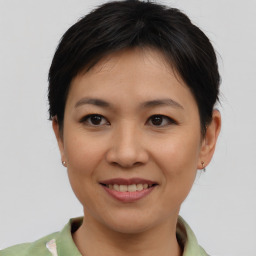 Joyful asian young-adult female with short  brown hair and brown eyes