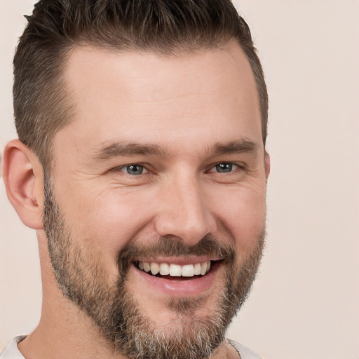 Joyful white young-adult male with short  brown hair and brown eyes