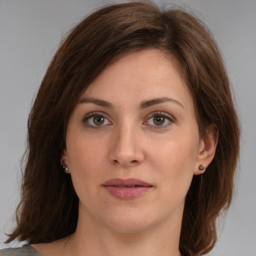 Joyful white young-adult female with medium  brown hair and green eyes