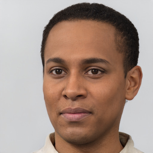 Joyful black young-adult male with short  black hair and brown eyes