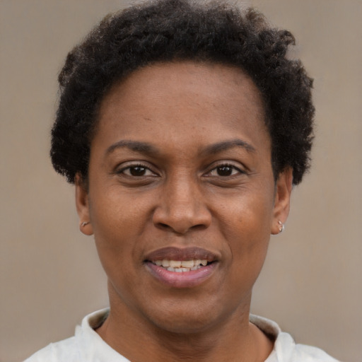 Joyful black adult female with short  brown hair and brown eyes