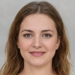 Joyful white young-adult female with medium  brown hair and green eyes