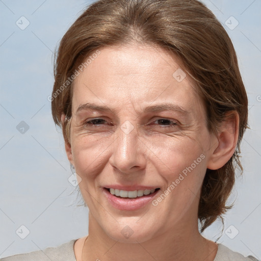 Joyful white adult female with medium  brown hair and grey eyes