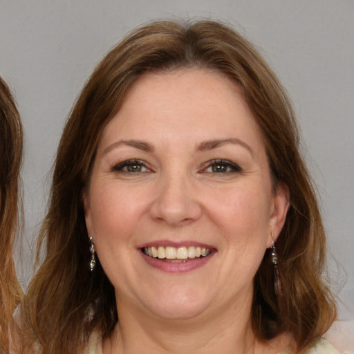 Joyful white adult female with medium  brown hair and brown eyes