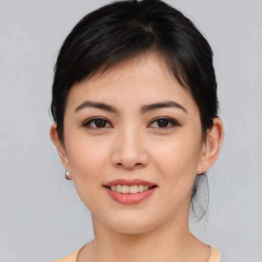 Joyful asian young-adult female with medium  black hair and brown eyes