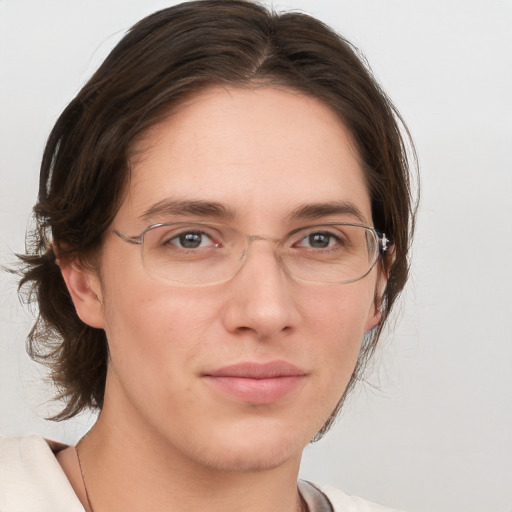 Joyful white adult female with medium  brown hair and brown eyes