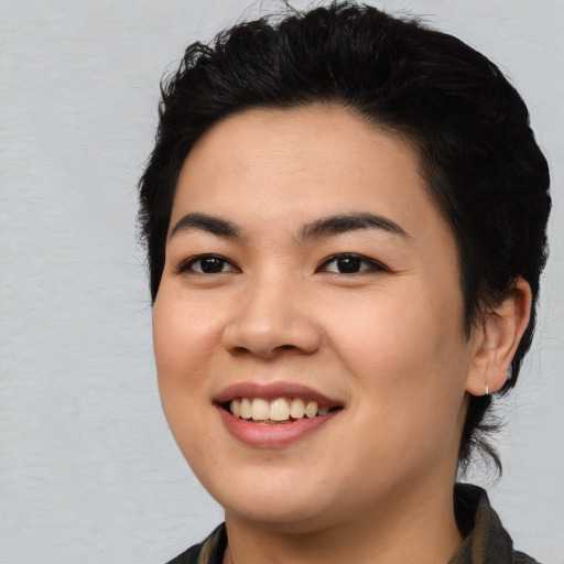 Joyful asian young-adult female with medium  black hair and brown eyes