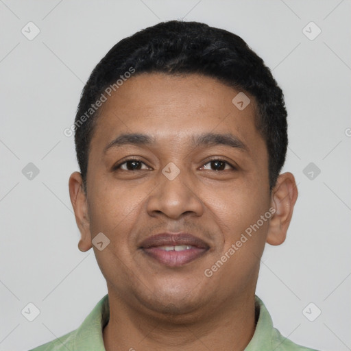 Joyful latino young-adult male with short  black hair and brown eyes