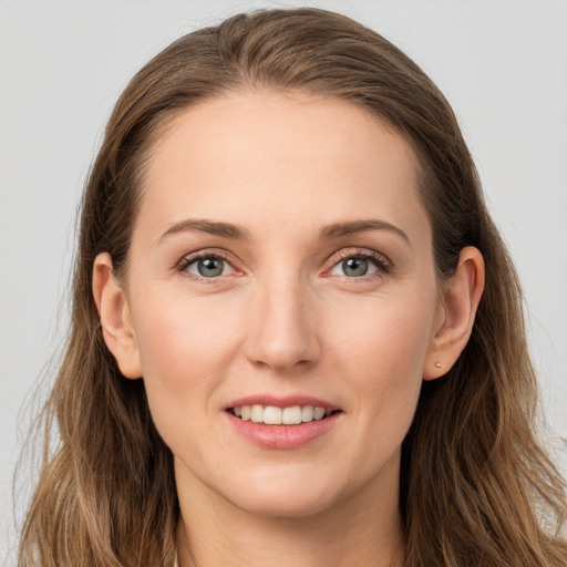 Joyful white young-adult female with long  brown hair and grey eyes