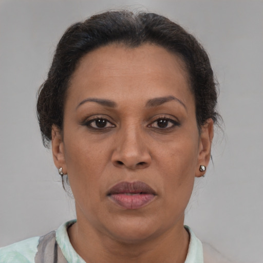 Joyful black adult female with short  brown hair and brown eyes