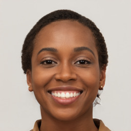 Joyful black young-adult female with short  brown hair and brown eyes