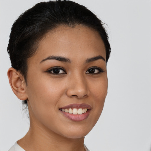 Joyful latino young-adult female with short  brown hair and brown eyes