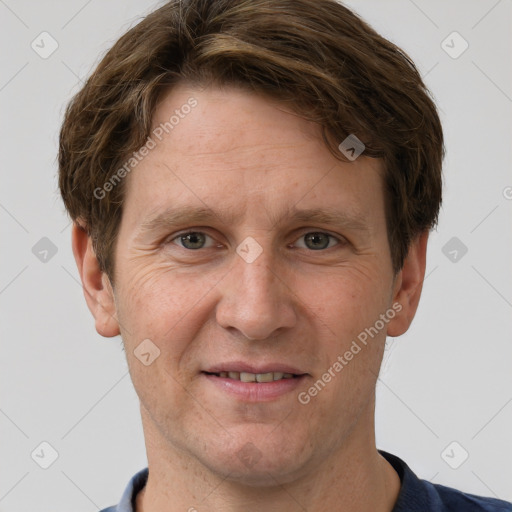 Joyful white adult male with short  brown hair and grey eyes