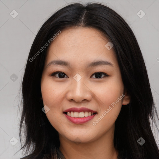 Joyful asian young-adult female with long  brown hair and brown eyes