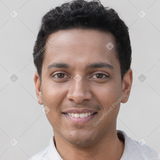 Joyful latino young-adult male with short  brown hair and brown eyes