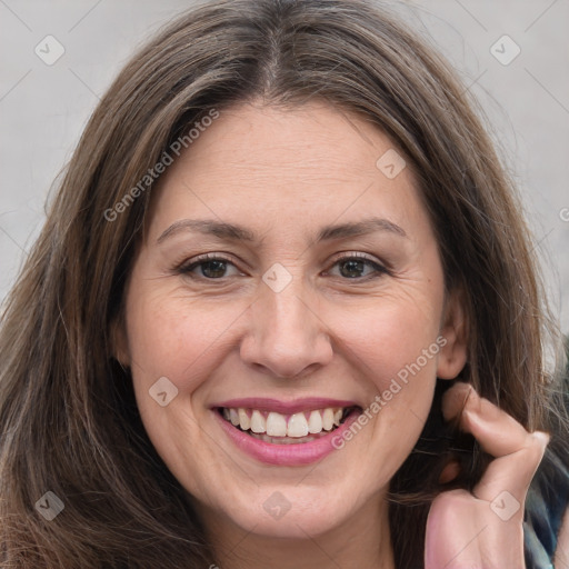 Joyful white adult female with long  brown hair and brown eyes