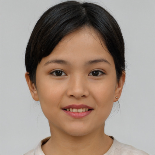 Joyful asian child female with short  brown hair and brown eyes