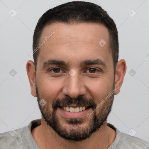 Joyful white young-adult male with short  black hair and brown eyes