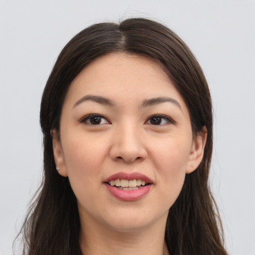Joyful asian young-adult female with long  brown hair and brown eyes