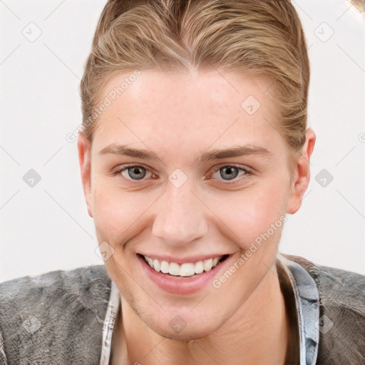 Joyful white young-adult female with short  brown hair and blue eyes