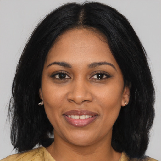 Joyful black young-adult female with medium  black hair and brown eyes