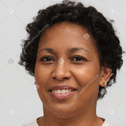 Joyful black adult female with short  brown hair and brown eyes