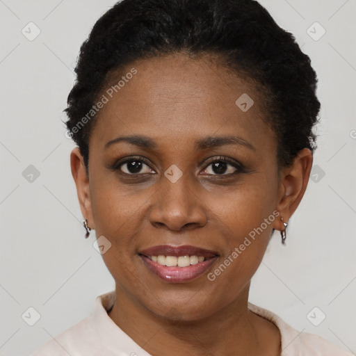 Joyful black young-adult female with short  black hair and brown eyes