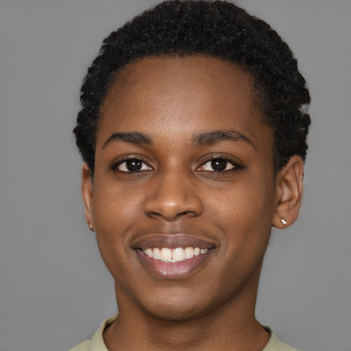 Joyful black young-adult female with short  black hair and brown eyes