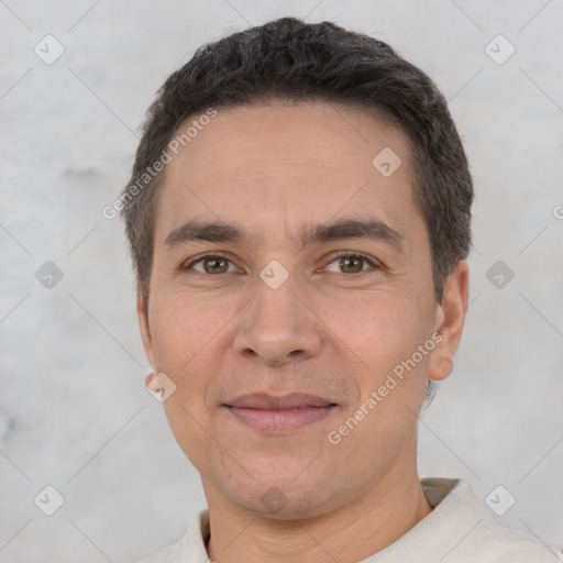 Joyful white adult male with short  brown hair and brown eyes