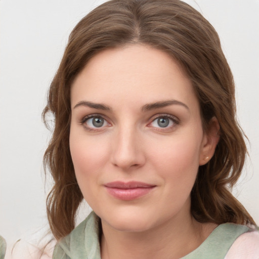 Joyful white young-adult female with medium  brown hair and green eyes