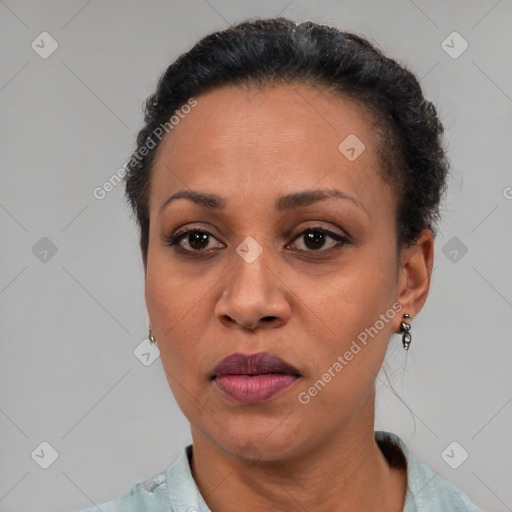 Joyful black adult female with short  brown hair and brown eyes