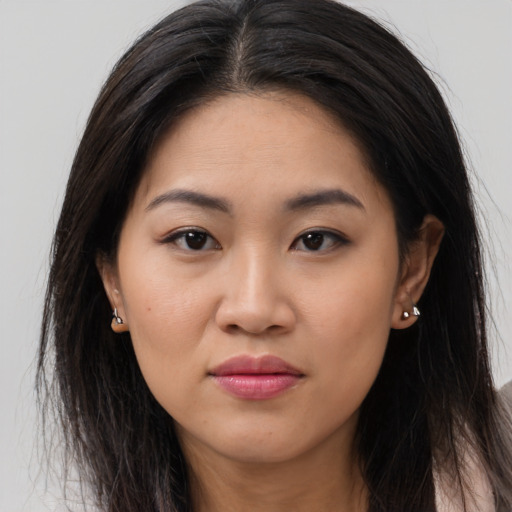 Joyful asian young-adult female with long  brown hair and brown eyes