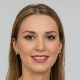 Joyful white young-adult female with long  brown hair and green eyes