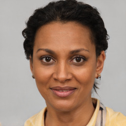 Joyful black adult female with short  brown hair and brown eyes