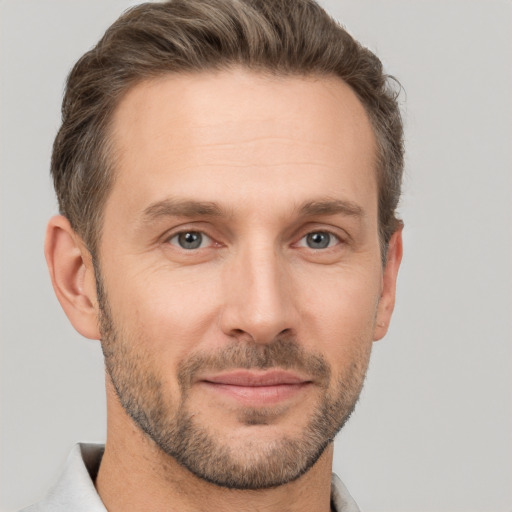 Joyful white adult male with short  brown hair and brown eyes