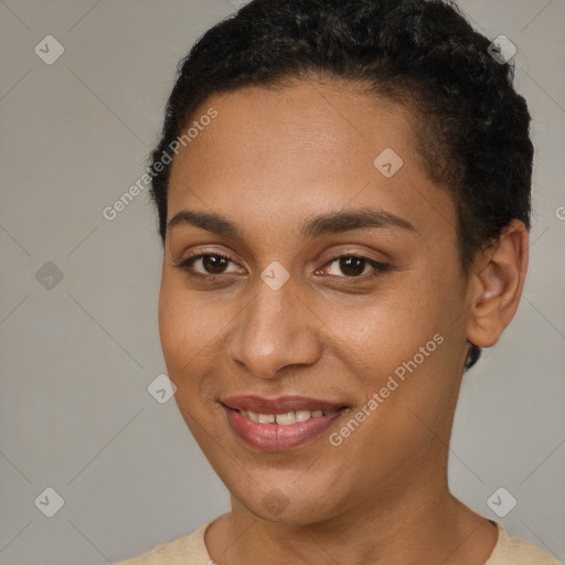 Joyful black young-adult female with short  brown hair and brown eyes