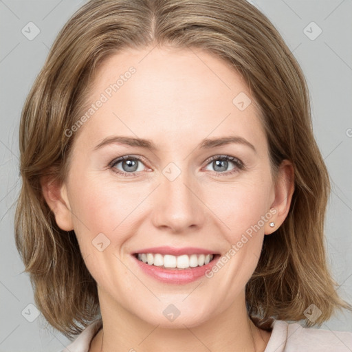 Joyful white young-adult female with medium  brown hair and blue eyes