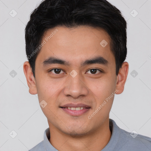 Joyful asian young-adult male with short  black hair and brown eyes