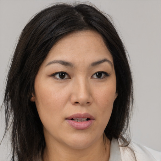 Neutral asian young-adult female with medium  brown hair and brown eyes