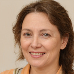 Joyful white adult female with long  brown hair and brown eyes