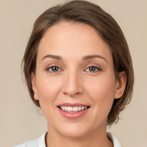 Joyful white young-adult female with medium  brown hair and green eyes