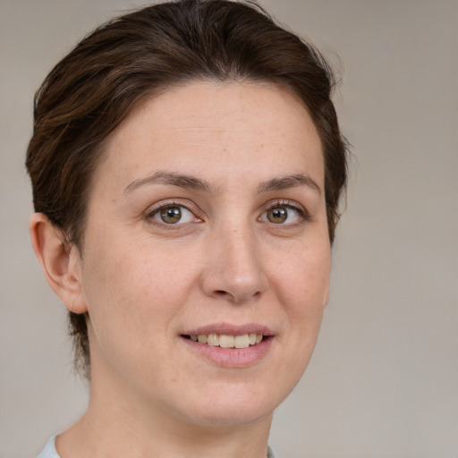 Joyful white adult female with medium  brown hair and grey eyes