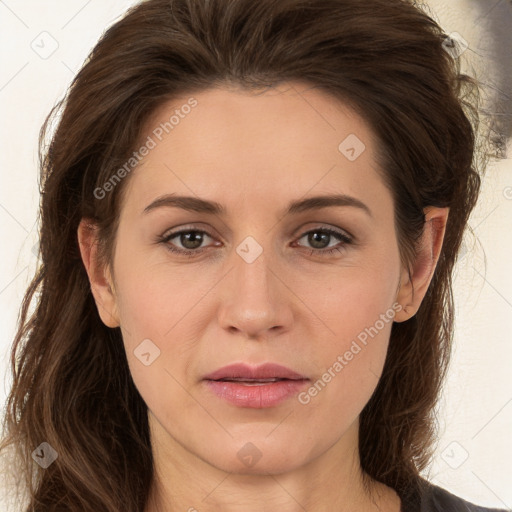 Joyful white adult female with long  brown hair and brown eyes