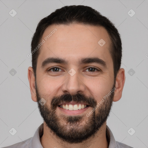 Joyful white young-adult male with short  black hair and brown eyes