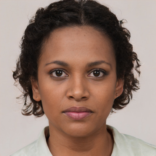 Neutral black young-adult female with medium  brown hair and brown eyes