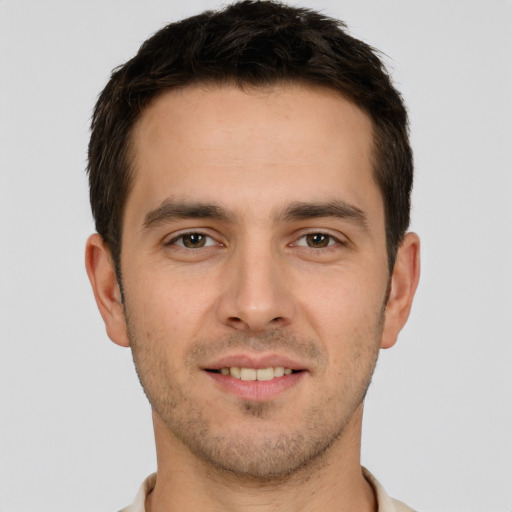 Joyful white young-adult male with short  brown hair and brown eyes